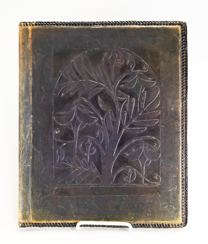 A tooled leather portfolio handmade by Helen