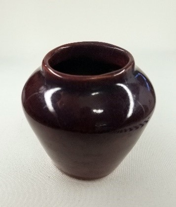 A red glazed vase handmade by Helen