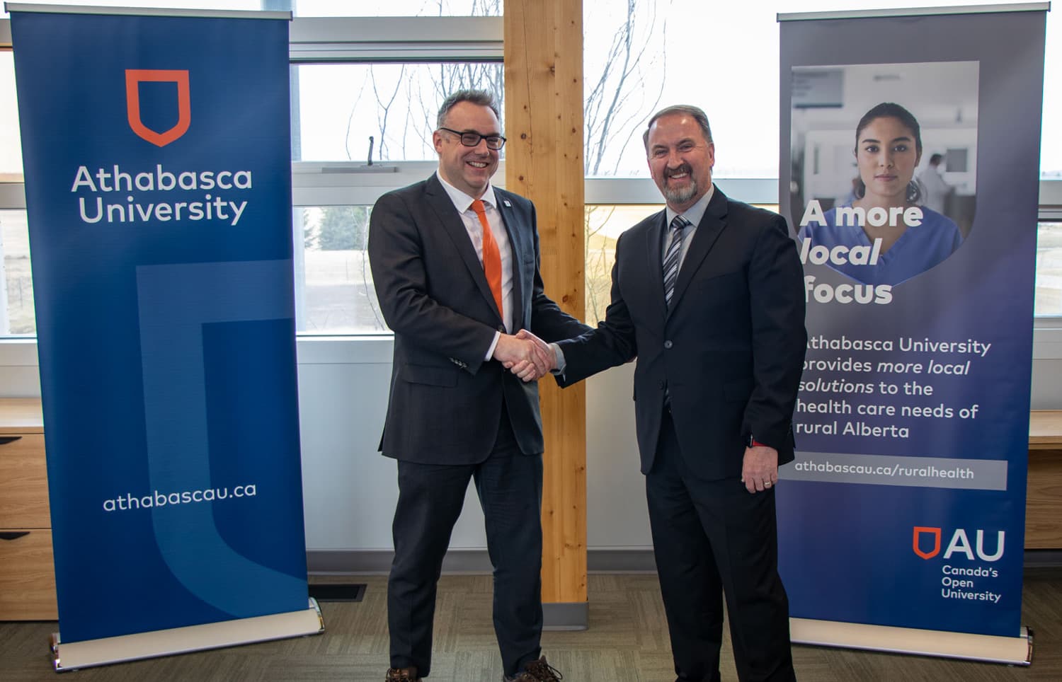 Athabascau University president and Northern Lakes College president shaking hands