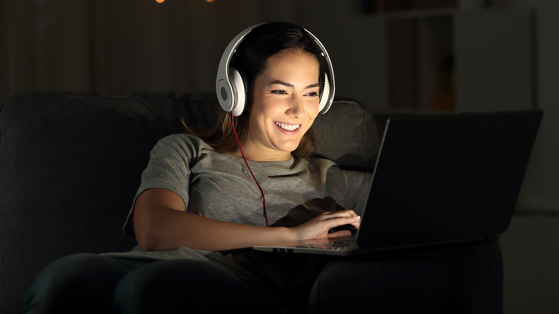 Student with headphones on working on laptop