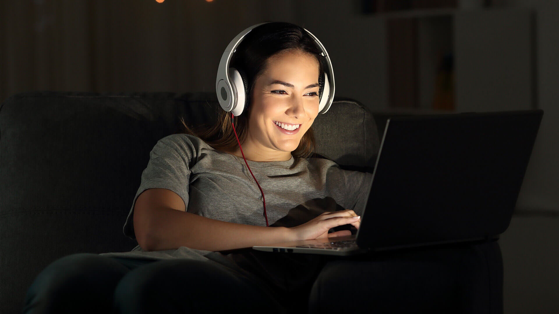 Student with headphones on working on laptop